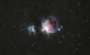 A breathtaking photograph of the Orion Nebula amidst a starry night sky, capturing celestial beauty.