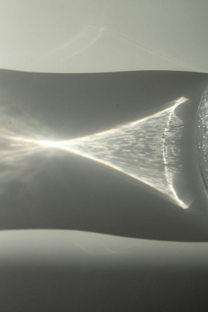 Subtle play of light reflections and shadows creating an abstract visual on a glass surface.